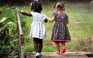 2 young girls walking together away from the camera.