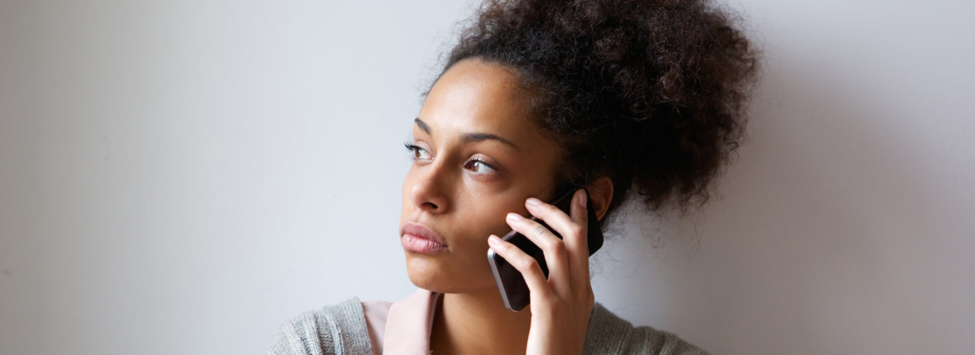 Concerned black woman on phone