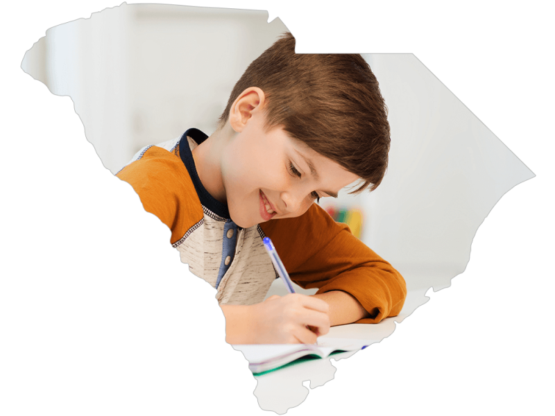 South Carolina shape with photo of young boy doing homework