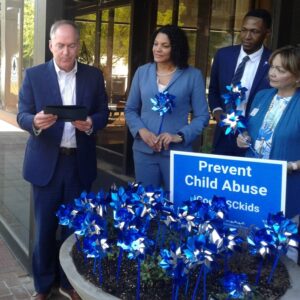 Tiffany Santagati CAP Month - Children's Trust of South Carolina Tiffany Santagati (center), recently elected as board secretary-treasurer, listens as Greenville mayor Knox White reads a proclamation at City Hall designating April as Child Abuse Prevention Month in the city of Greenville.