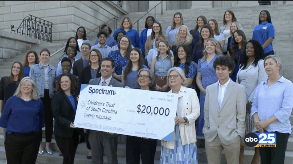 Spectrum presenting a check to Children's Trust staff