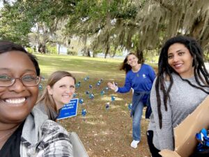 Hopeful Horizons staff smiling with pinwheels.