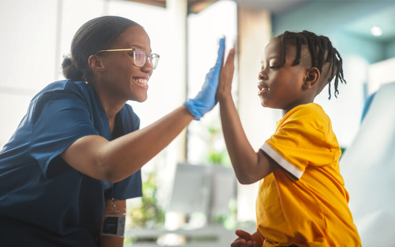 Child_giving_nurse_high_five - Children's Trust of South Carolina Timeline main image