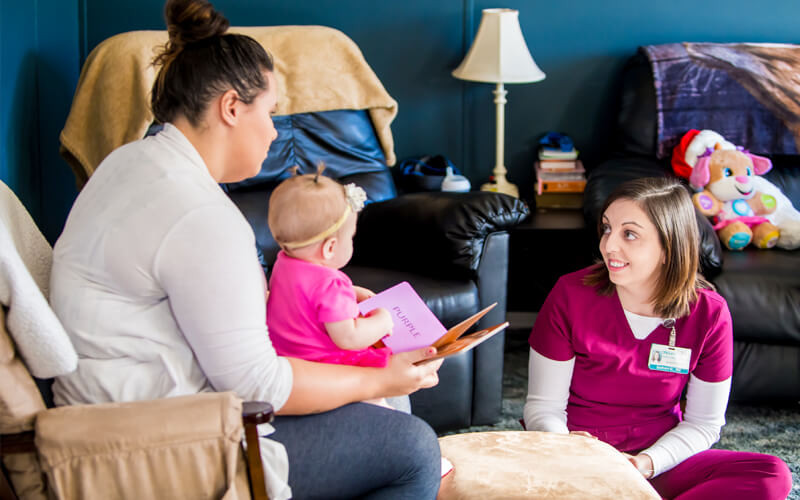 Nurse at a home visit in Chesterfield with a mom and her baby girl.