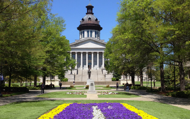 South Carolina State House exterior with spring flowers.
