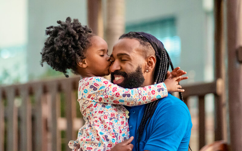 Portrait-of-father-and-little-daughter-on-playground