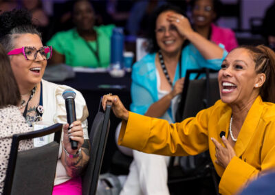 Princess Sarah laughs while speaking with an attendee during her keynote at the 2024 Building Hope for Children Conference.