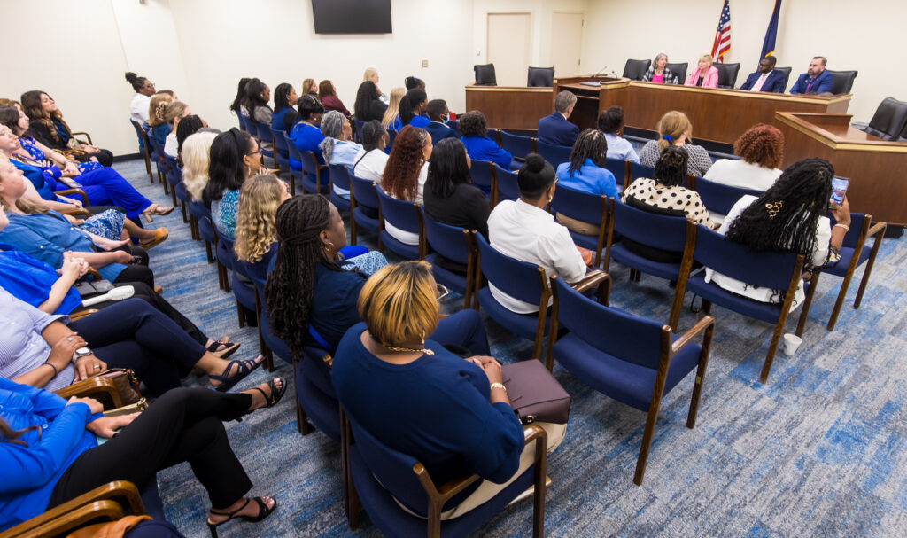 Home visitors listen to a palen of lawmakers