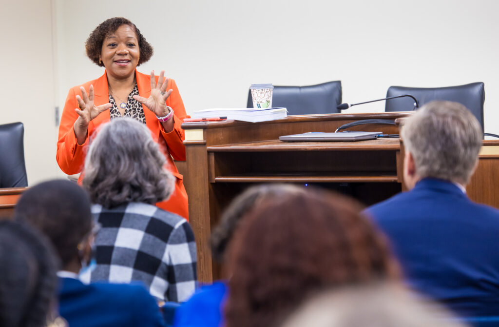 Senator Tameika Isaac Devine speaks to home visitors