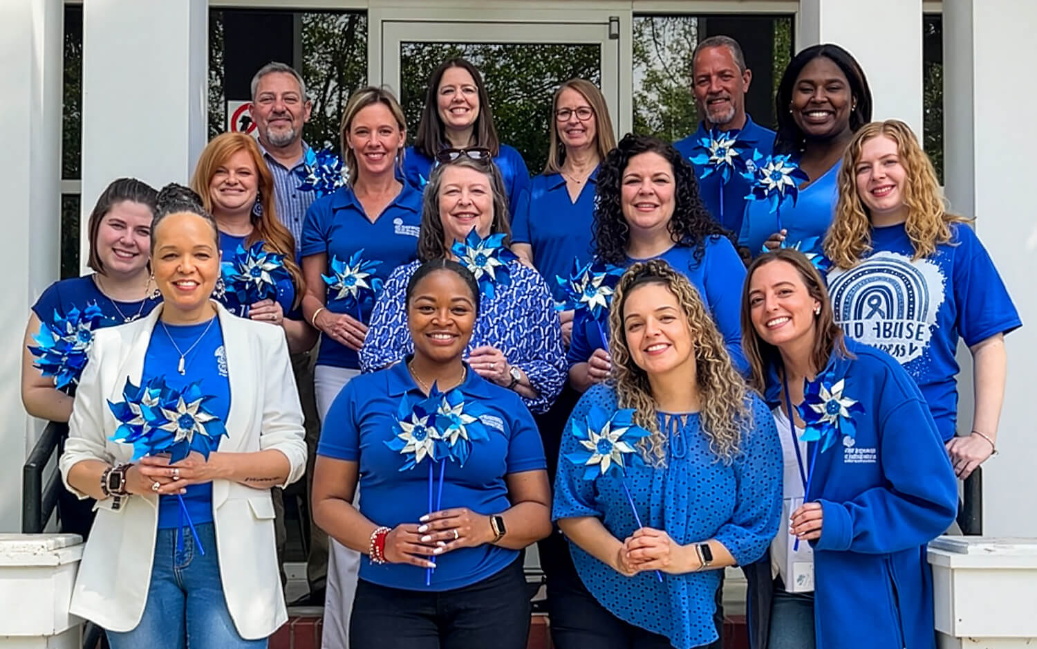 Community partner members holding pinwheels.