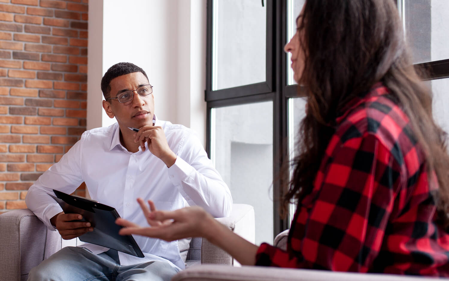 Counselor listens to patient during a session.