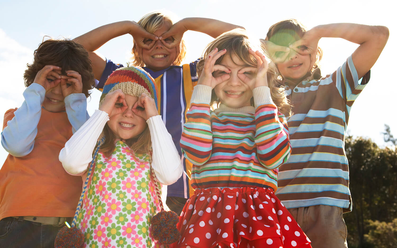 Five children with fingers over eyes.