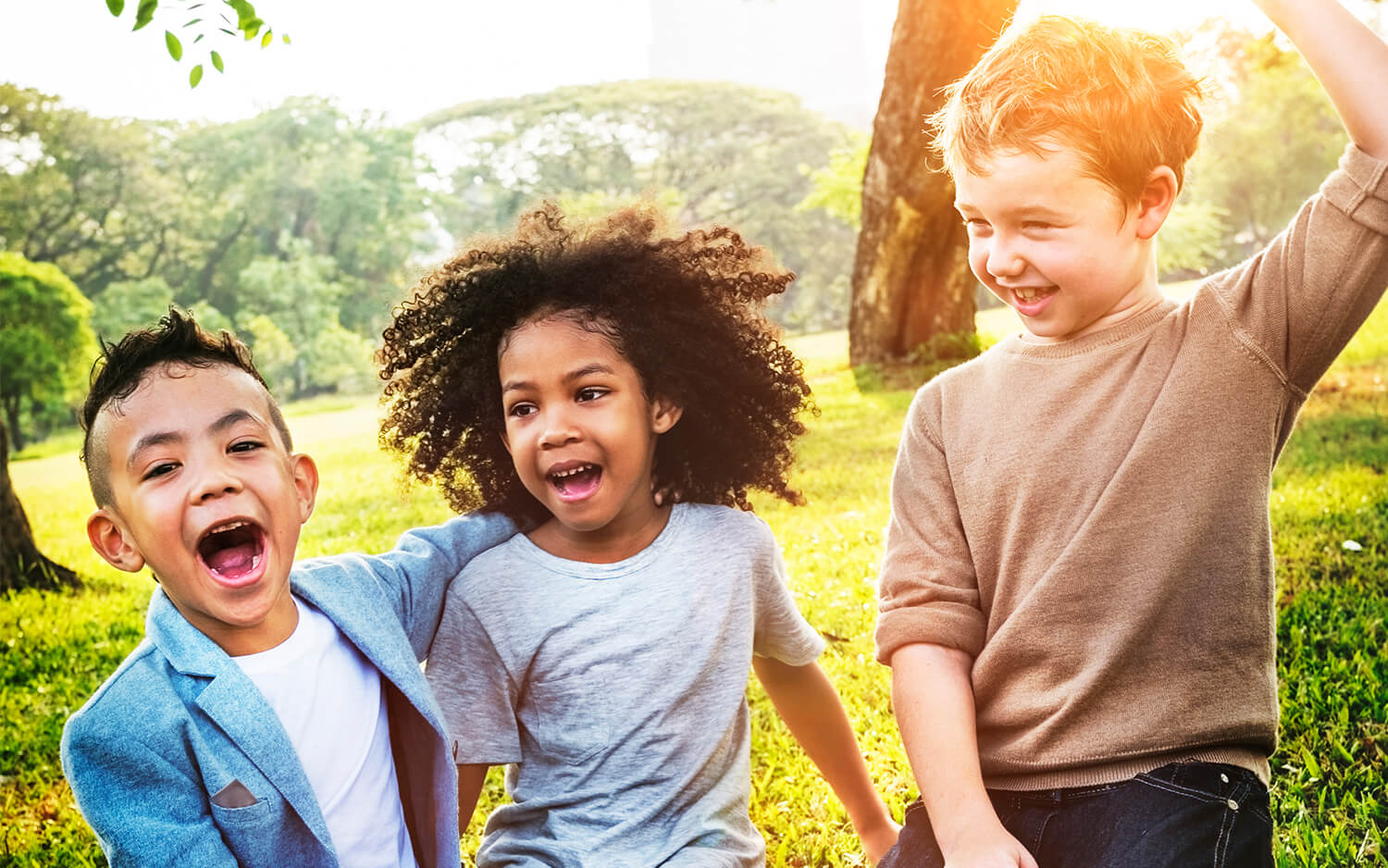 Three kids playing together outside.