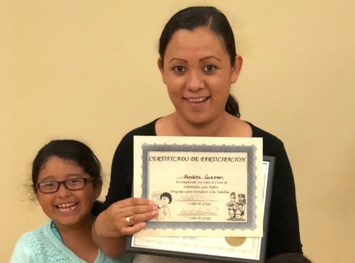 Andrea Guzman displays graduation certificate