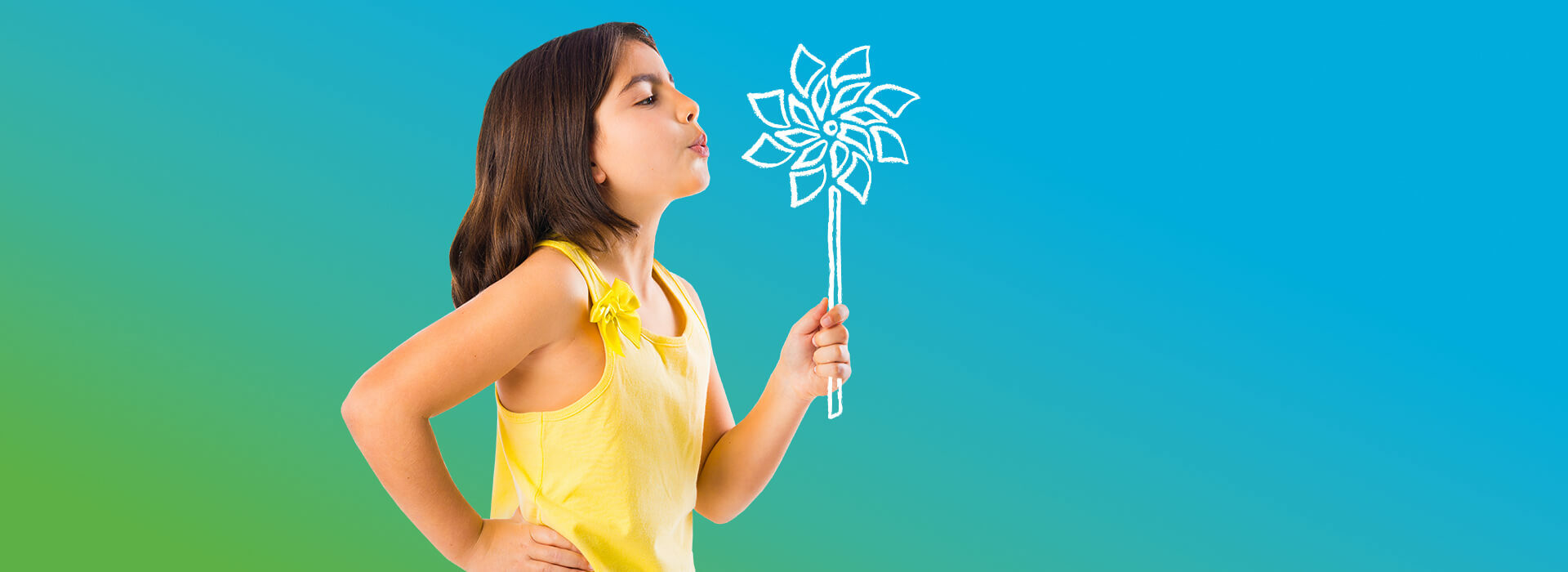Young girl blowing at a pinwheel.