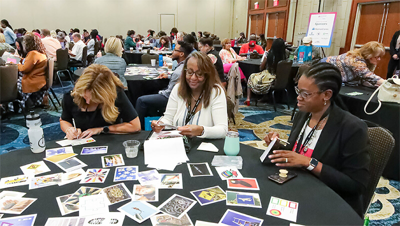 Conference attendees work together during a breakout session.