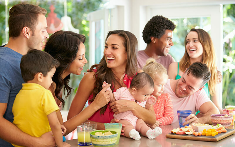 Group of families enjoying snacks at home
