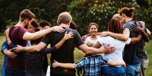 Group-of-people-huddle-together-in-the-park