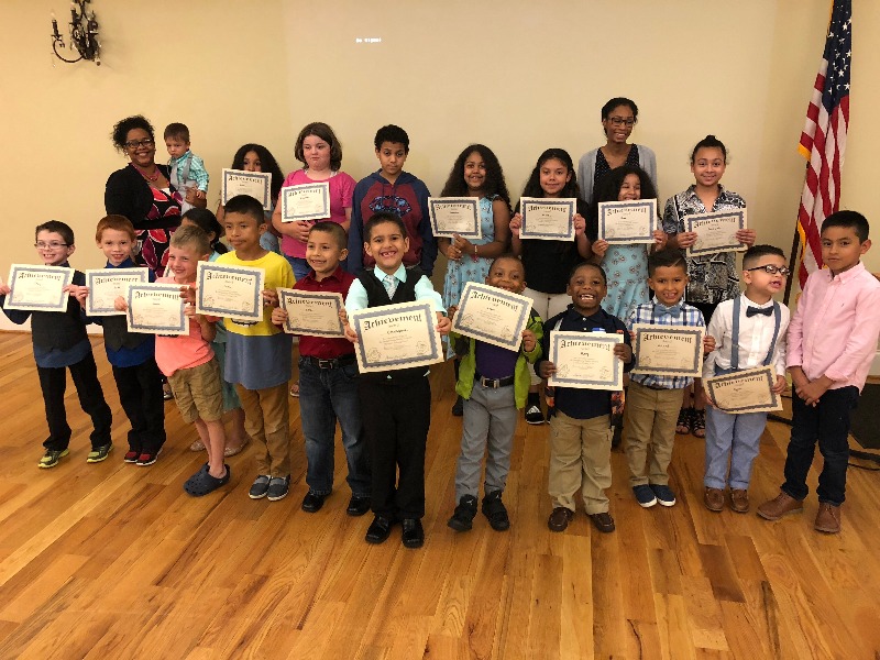 Children holding graduation certificates at SFP ceremony