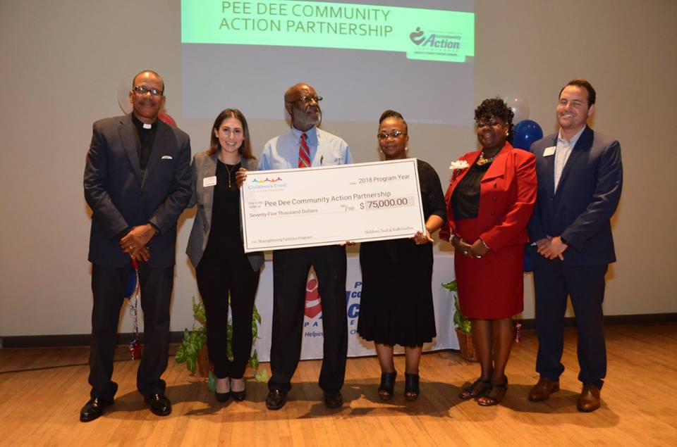 Children's Trust presents check to Pee Dee Community Action Partnership to implement the Strengthening Families Program.