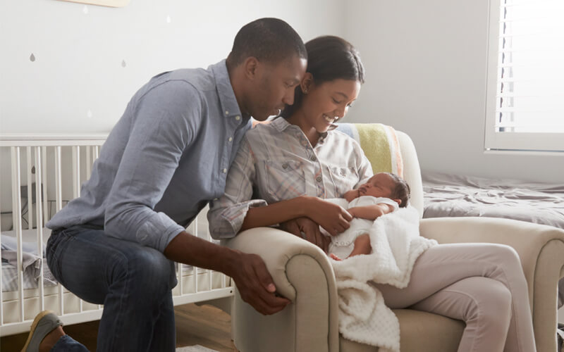 Young black couple with their newborn baby.