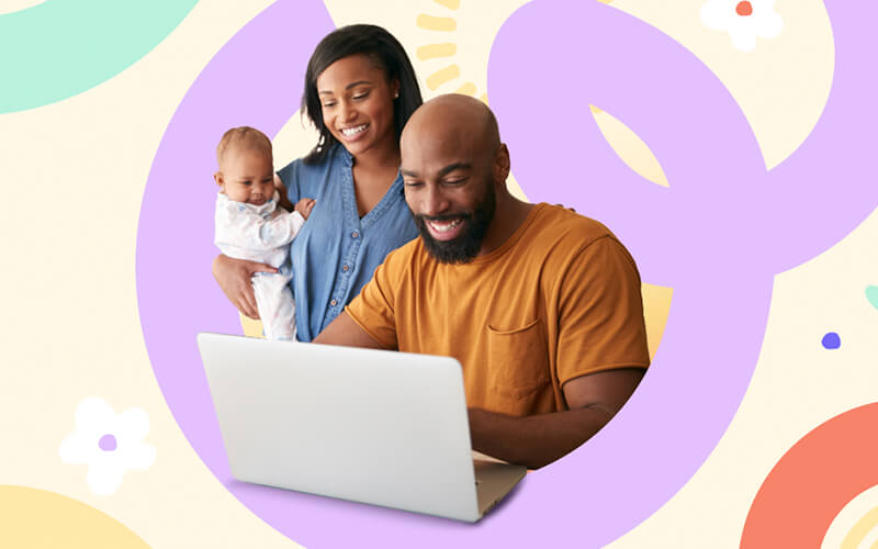 Young black man on a laptop while a young black woman is beside him holding a baby.