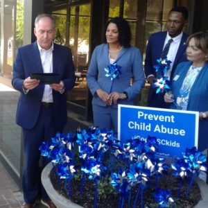 Tiffany Santagati (center), recently elected as board secretary-treasurer, listens as Greenville mayor Knox White reads a proclamation at City Hall designating April as Child Abuse Prevention Month in the city of Greenville. 