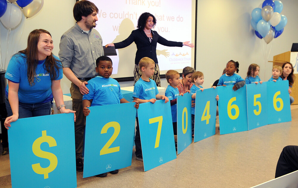 Upstate-Investment-Announcement-Kids-holding-dollar-amount-signs