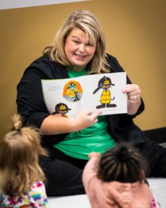 Jessica Elliott, Parenting Partnerships and Family Resource Center coordinator, reads to kids at a community event.